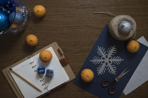 Top down view on table with Christmas decoration setup and tangerines. Stock Photos