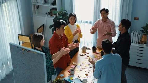Top down view of team clapping hands to celebrate increasing sales. Convocation. Stock Photos