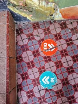 A top-down view of a tiled floor with a red and grey geometric octagonal pa.. Stock Photos