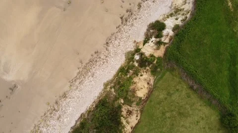 Top down view &amp; tilt up along the beach in playa de Oyambre, Cantabria, Spain 4K Stock Footage 155599214