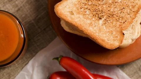 Top Down View of Toasted Bread, Chili Peppers, and Francesinha Sauce on a R.. 스톡 사진