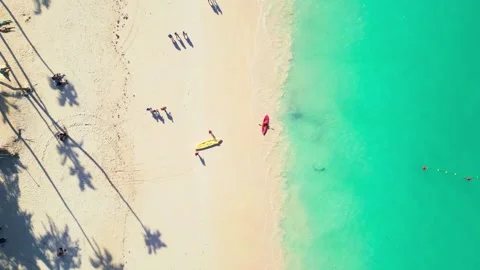 Top-down view of tourists arriving at a tourist beach in Punta Cana by kayak Stock Footage 308023829