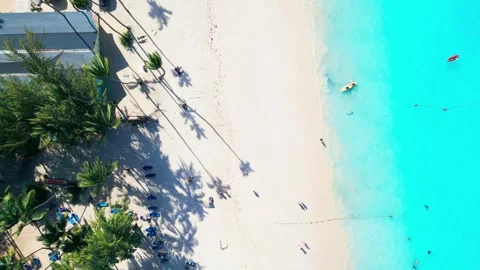 Top-down view of tourists arriving at a tourist beach in Punta Cana by kayak Stock Footage 309069968