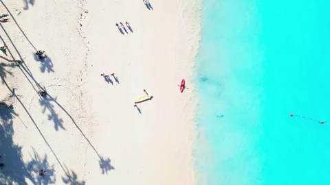 Top-down view of tourists arriving at a tourist beach in Punta Cana by kayak Stock Footage 309070988