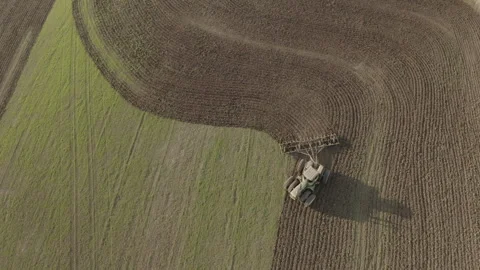 Top down view of tractor plowing field Stockbeeldmateriaal 251896699