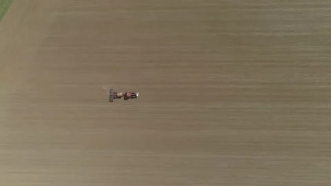 Top down view of a tractor sowing rapeseed in the field Stock Footage 159807075