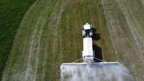 Top Down View of Tractor Spreading Agricultural Lime Across Grassland in Austria Video stock 347077566