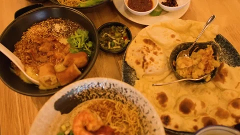 Top Down View of Traditional Burmese Cuisine Feast on Wooden Table Stock Footage 345470919