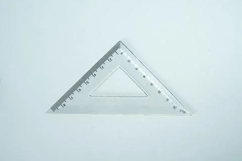 Top-down view of a transparent plastic drafting triangle ruler on a clean, .. Stock Photos