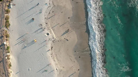 Top down view travelling along the beach with blue waves on the side Stock Footage 170724287