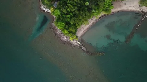 Top down view of tropical coast line with blue water and sandy beach Stock Footage 256942570
