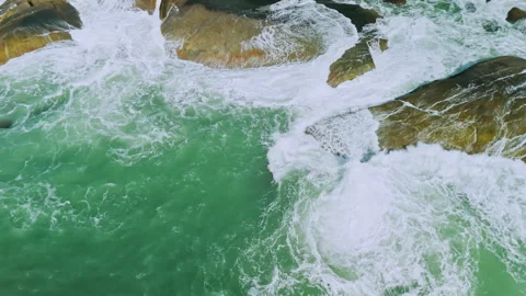 Top down view of tropical coastal line with rocks and huge waves with white foam Stock Footage 331622342