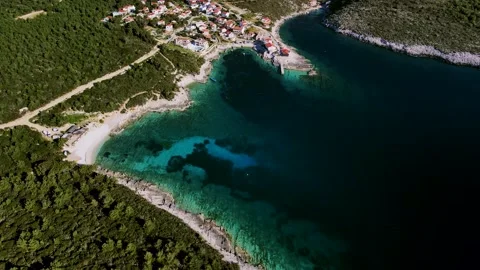 Top down view of a tropical Mediterranean town located on an island beach Stock Footage 169004042