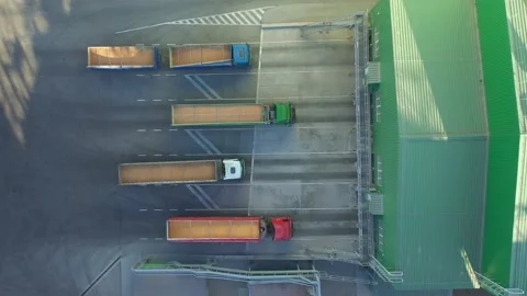 Top down view of trucks with trailers full of grain waiting to unload goods at t Stock Footage 155801522