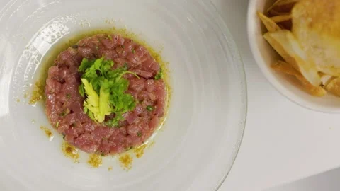 Top down view of tuna tartar on a white plate, fine dining, fancy restaurant Stock Footage 248208479