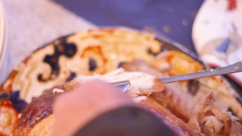 Top Down View of Turkey Meat Being Carved at Dinner Table After Roasting in the Stock Footage 295928392