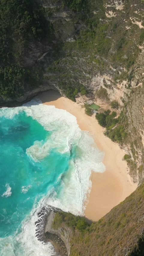 Top-down view of turquoise ocean waves crashing onto tropical remote beach Bali Stock Footage 312910829