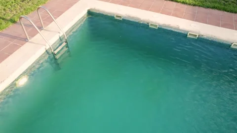 Top down view of turquoise water in a backyard pool leisure and luxury concep 스톡 동영상 314543996