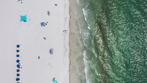 Top-Down View of Turquoise Waters Meeting White Sands with Beach Setup Video stock 336704878