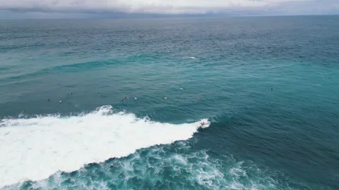 Top-Down View of Turquoise Waves Crashing on Rocky Shore Stock Footage 314987613