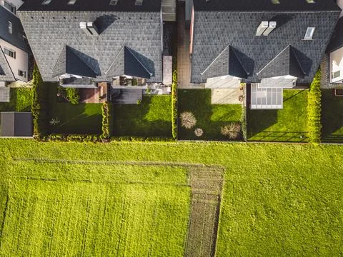 Top down view of two duples family houses next to a large country field Stock Photos