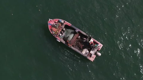 Top down view of two unidenfitiable fishermen inside an old wooden fishing boat Stock Footage 237119821