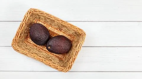 Top down view, two whole dark brown avocado (Hass / Bilse variety) in square  Stock Photos