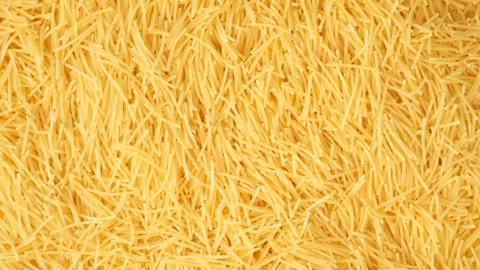 Top-down view of uncooked, dry, and short vermicelli pasta. 스톡 동영상 328499451