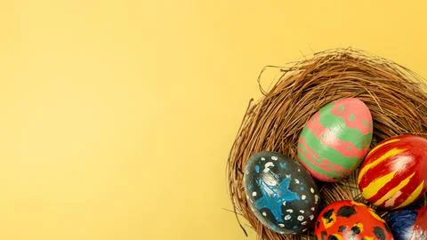 Top-down view of uniquely hand-painted Easter eggs in a bird's nest on a vi.. Stock Photos