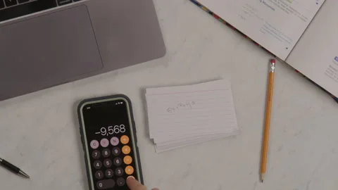 Top Down View of Unknown Student Doing Math Homework with Calculator Stock Footage 217772494