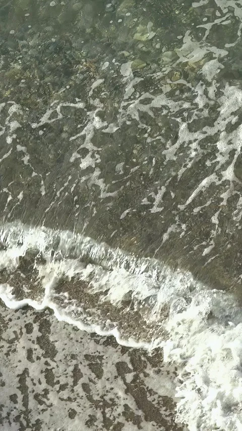 Top down view vertical video of the water waves on Mediterranean sea beach. Stock Footage 338314663