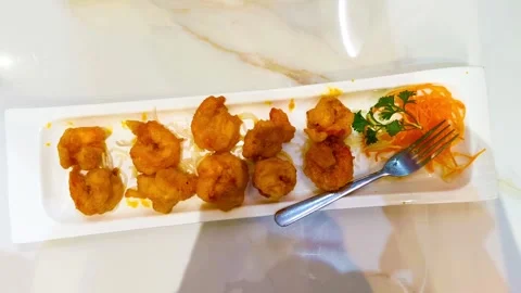 Top-down view of vibrant delicious fried crispy egg yolk shrimp garnished w.. Video stock 318247471