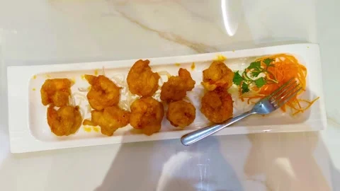 Top-down view of vibrant delicious fried crispy egg yolk shrimp garnished w.. Stock Footage 318247530