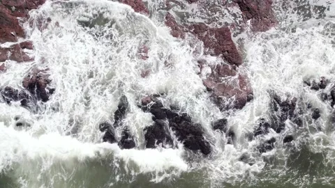 Top down view on waces breaks on rocks on sunset Stock Footage 219292700