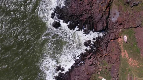 Top down view on waces breaks on rocks on sunset Stock Footage 219292736