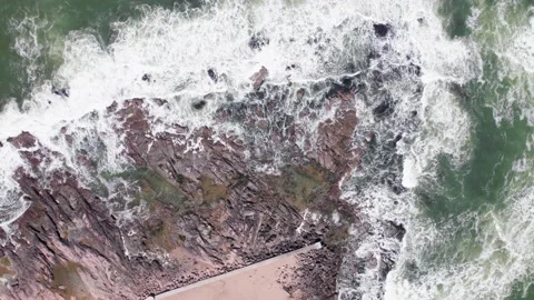 Top down view on waces breaks on rocks on sunset Stock Footage 220917773