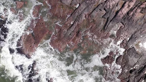 Top down view on waces breaks on rocks on sunset Stock Footage 222047481