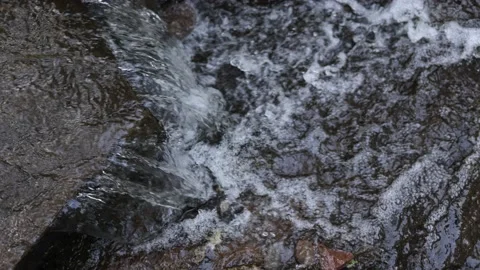 Top Down View of Water Flowing Over Rock Waterfall - Shallow Depth of Field Stock Footage 156035466