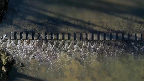 Top down view of water flowing between steps in river bed Stock Footage 263665144