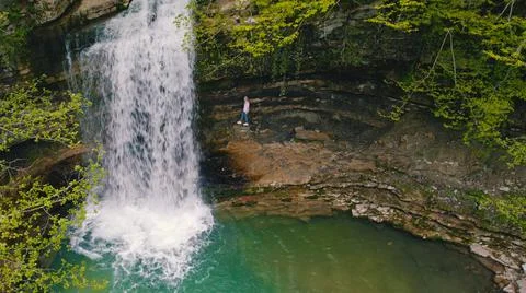 Top-down view of a waterfall and s small green lake Stock Photos