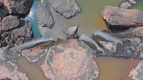 Top-Down View of a Waterfall Flowing into Rocky Pool Stock Footage 279453976