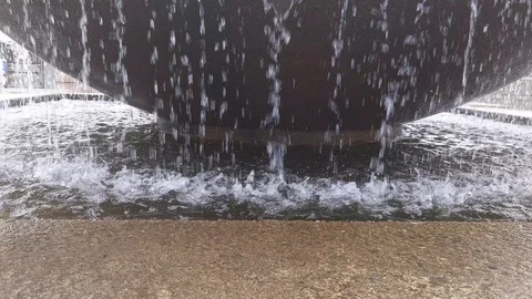 Top down view of a waterfall gushing over the edge in a water fountain Stock Footage 122080930