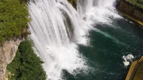 Top-down view of waterfall spilling over stone barrier, Bosnia and Herzegovina, Stock Footage 326200621