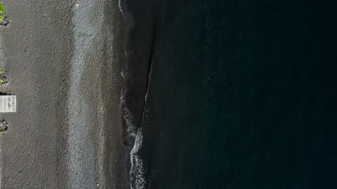 Top down view on waves on black sand beach Stock Footage 159639846