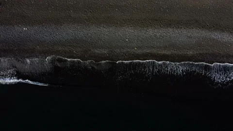 Top down view on waves on black sand beach Stock Footage 162568689
