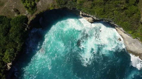 Top down view on waves break on rock cliff Stock Footage 159331031
