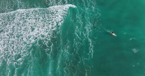 Top down view of waves breaking and surfer surfing on waves. Aerial view Stock Footage 191722293