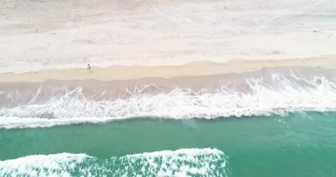 A Top Down View of Waves Crashing on a Beach. Concept The endless rhythm of.. Stock Footage 314543456