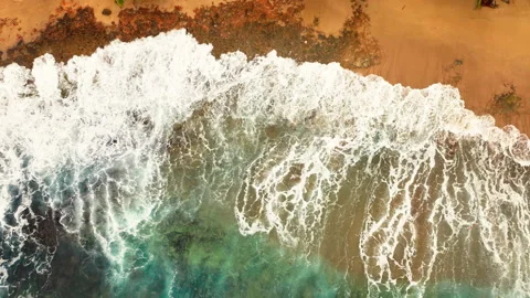 Top down view of waves crashing on sandy beach Stock Footage 330584407