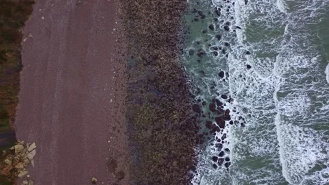 Top down view of waves on a rocky beach. Aerial, copy space Stock Footage 331955627